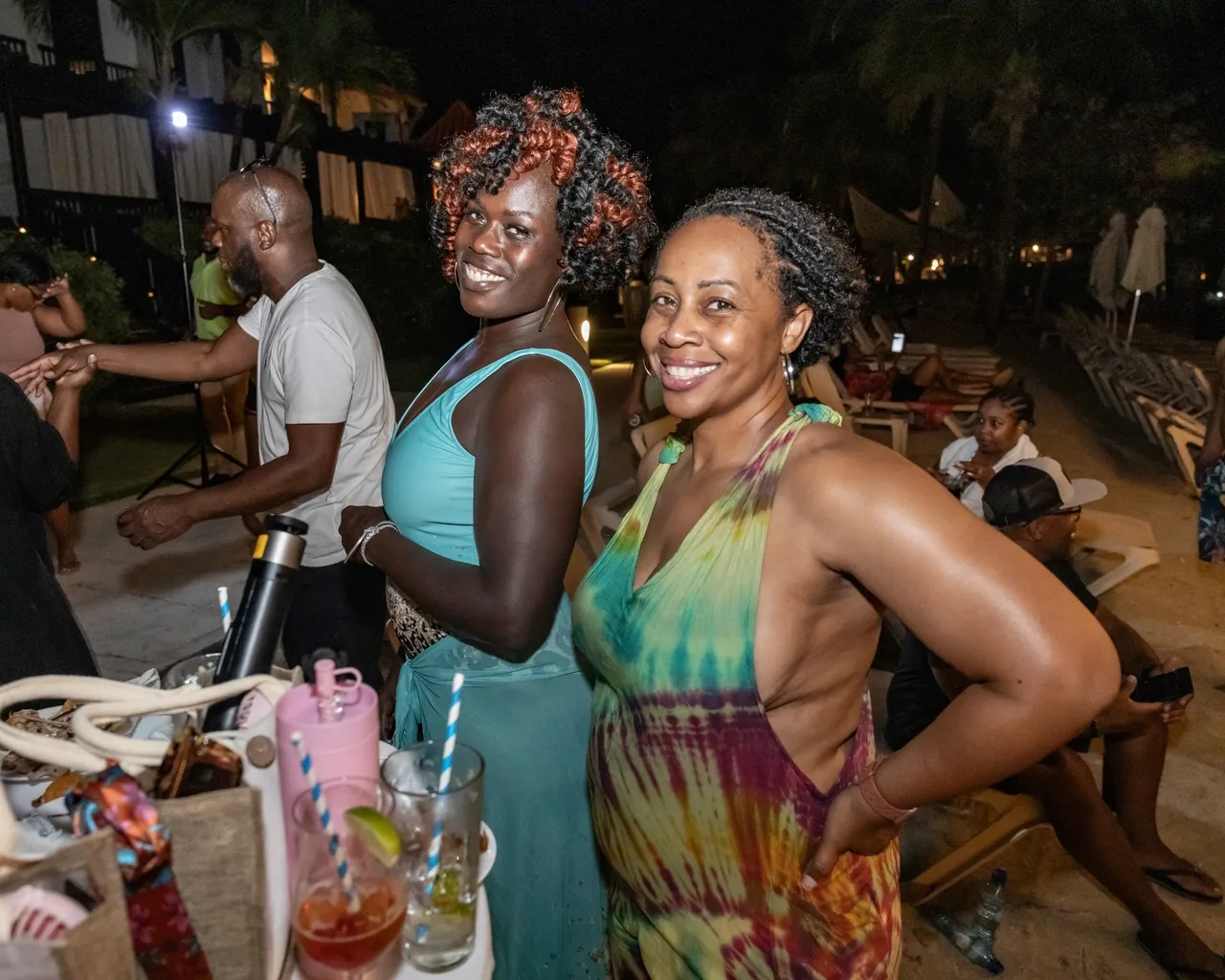 Two women standing next to each other at a party.