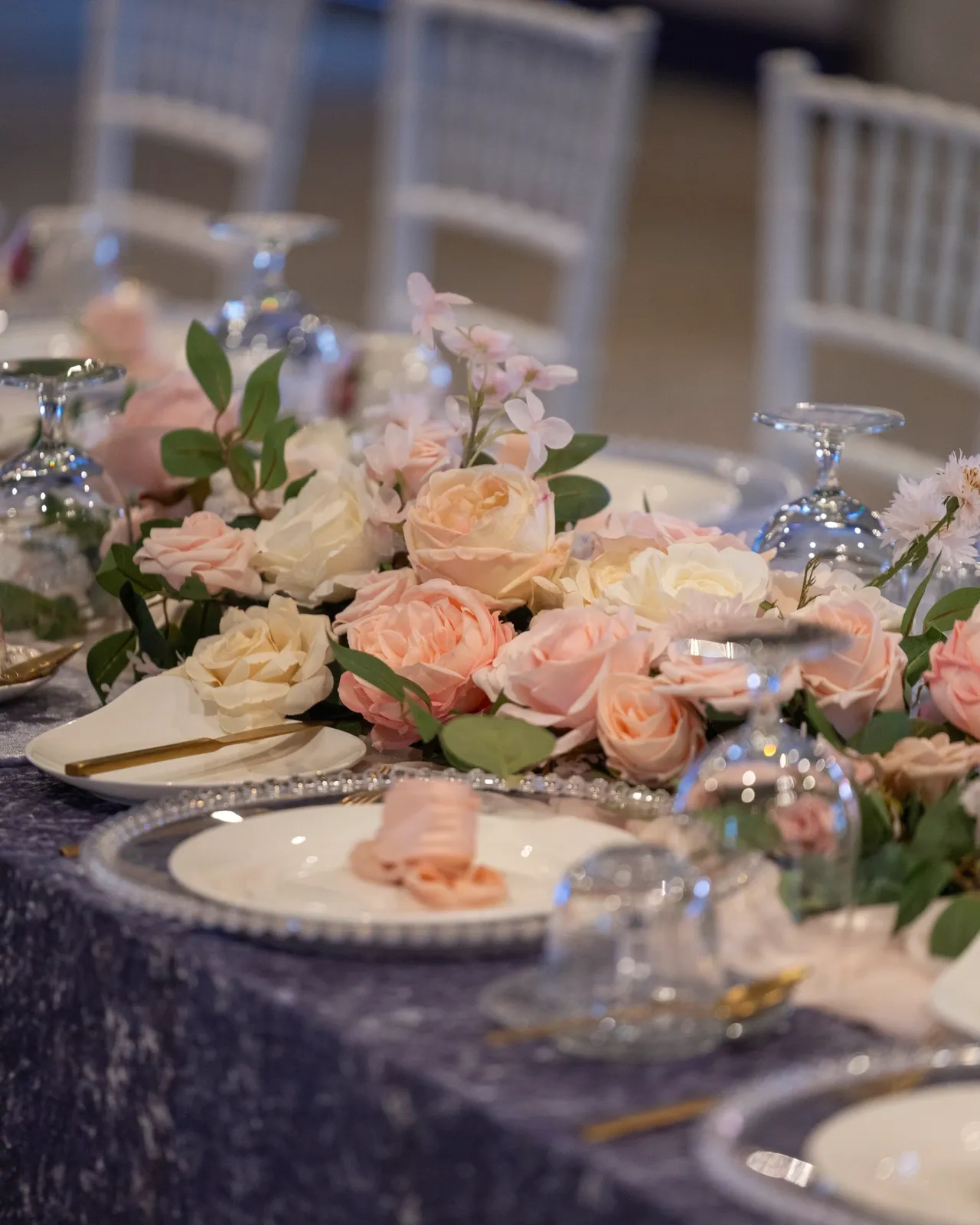 A table set with plates and flowers on it.