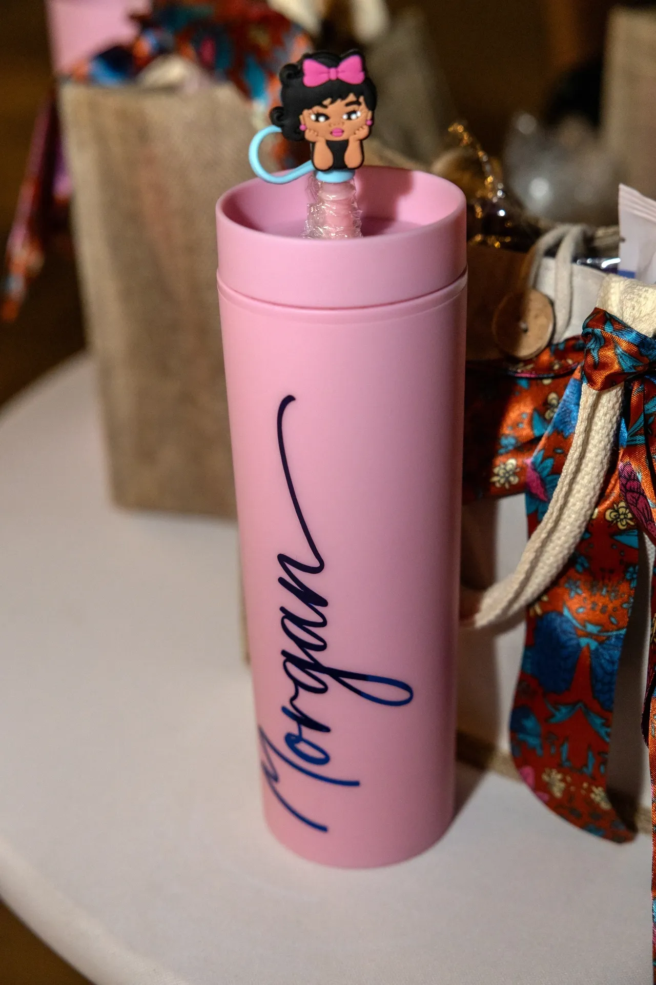 A pink cup with a blue handle and name morgan