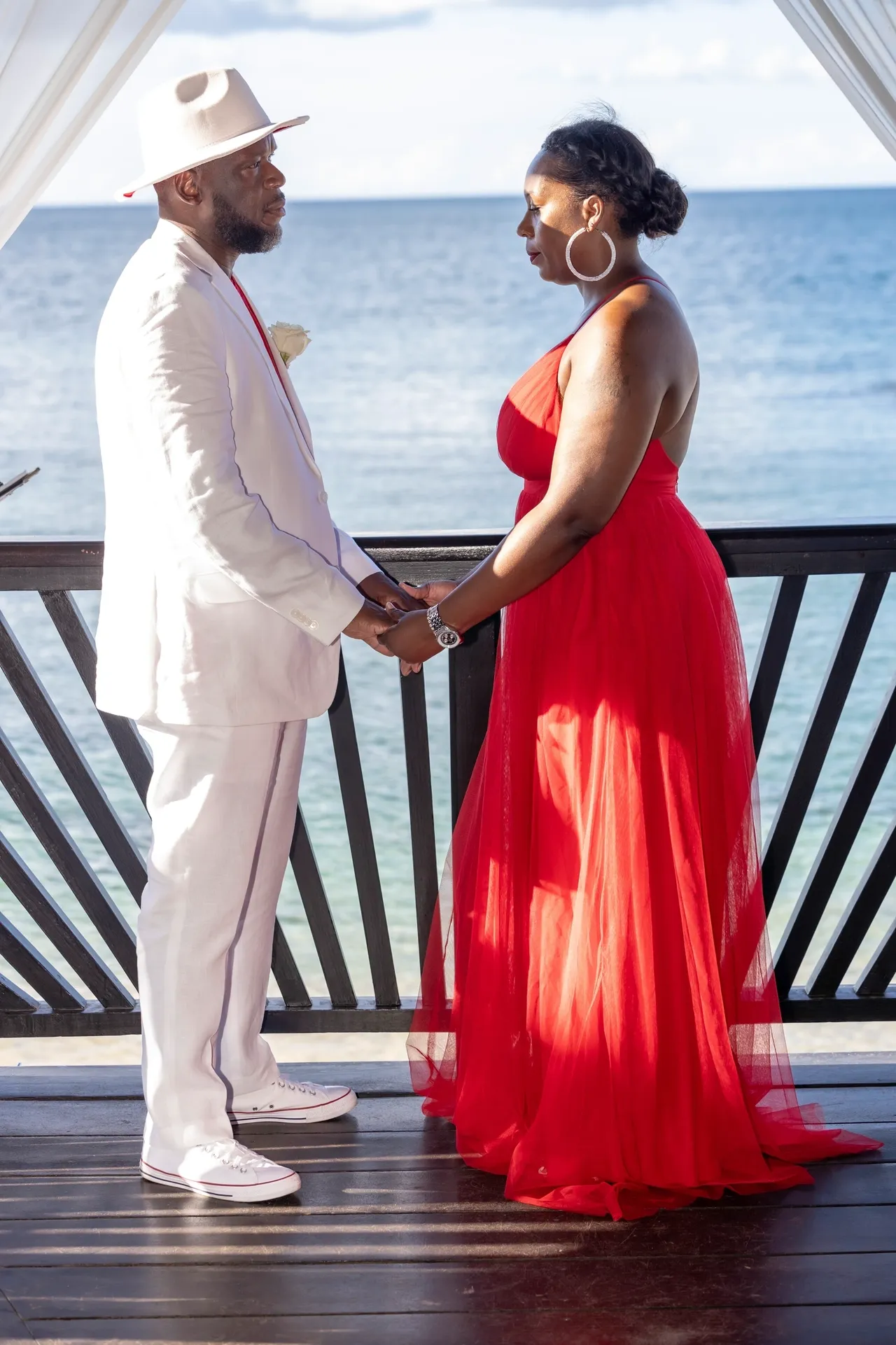 A man and woman holding hands while standing next to each other.