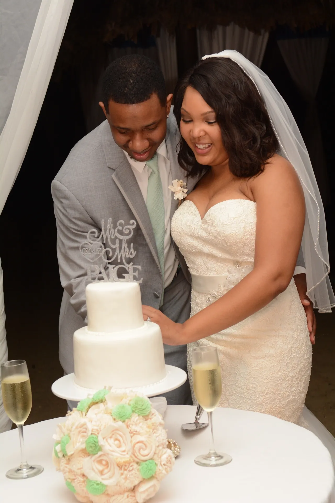 A couple cutting their wedding cake at the reception.