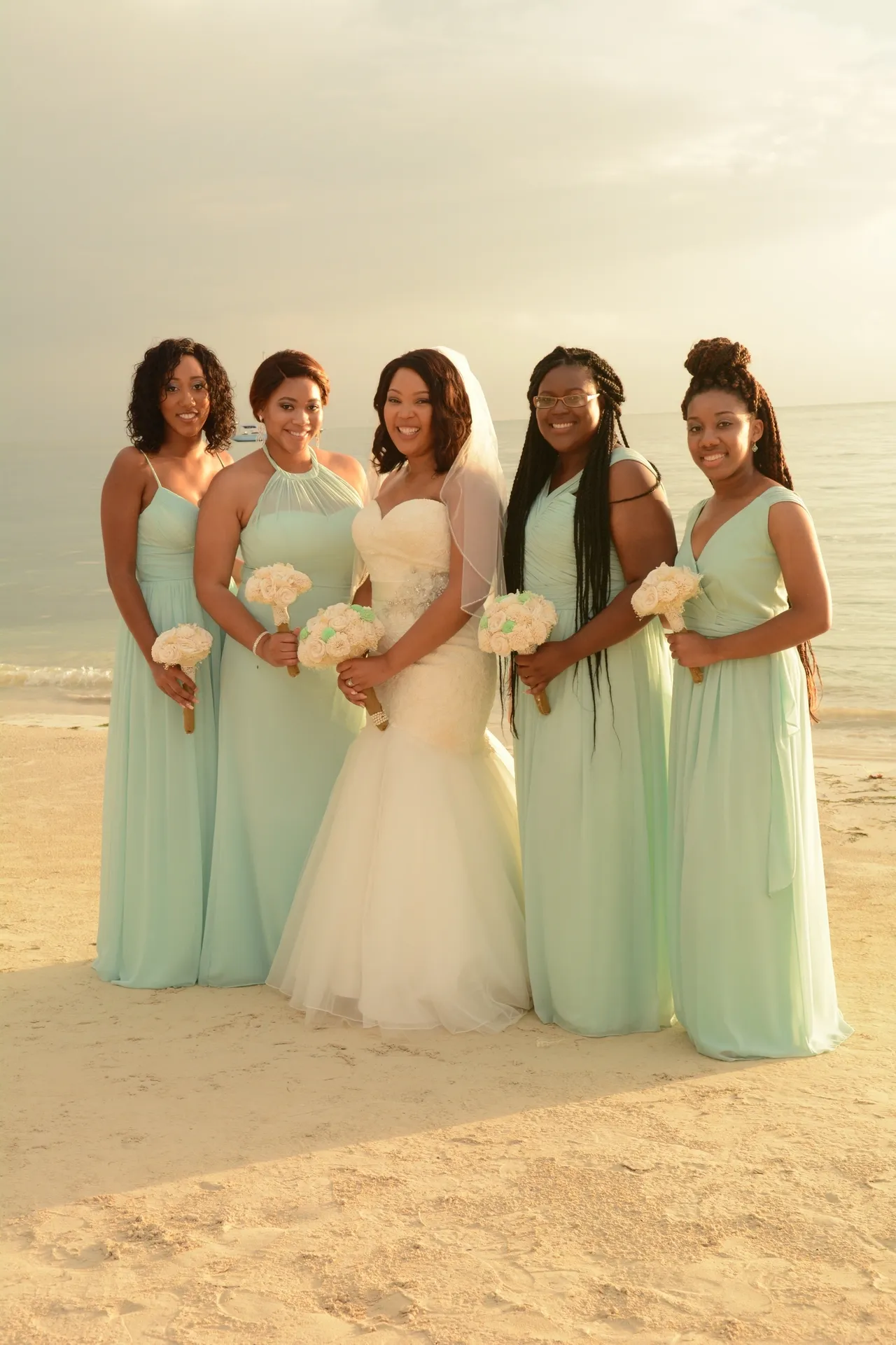 A group of women standing on the beach.