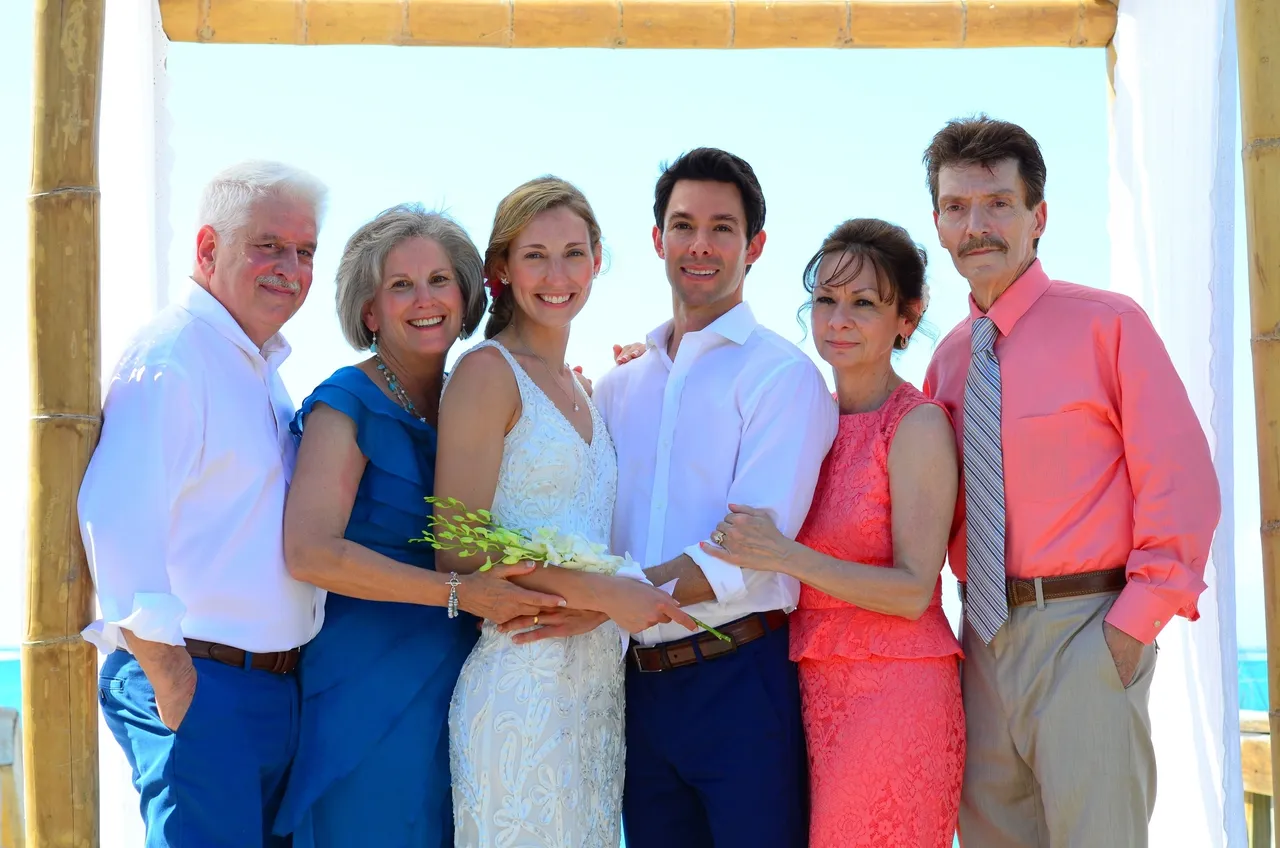 A group of people standing together holding hands.