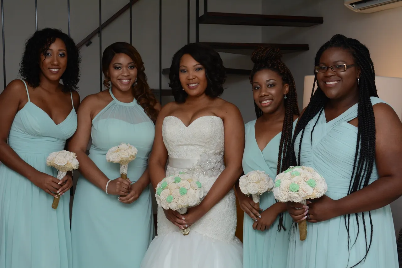 A group of women holding flowers in their hands.