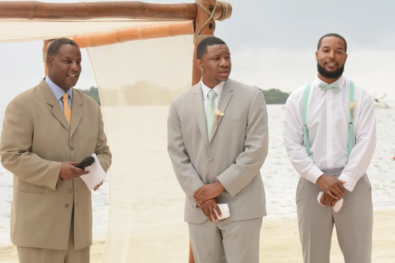 Three men in suits standing next to each other.