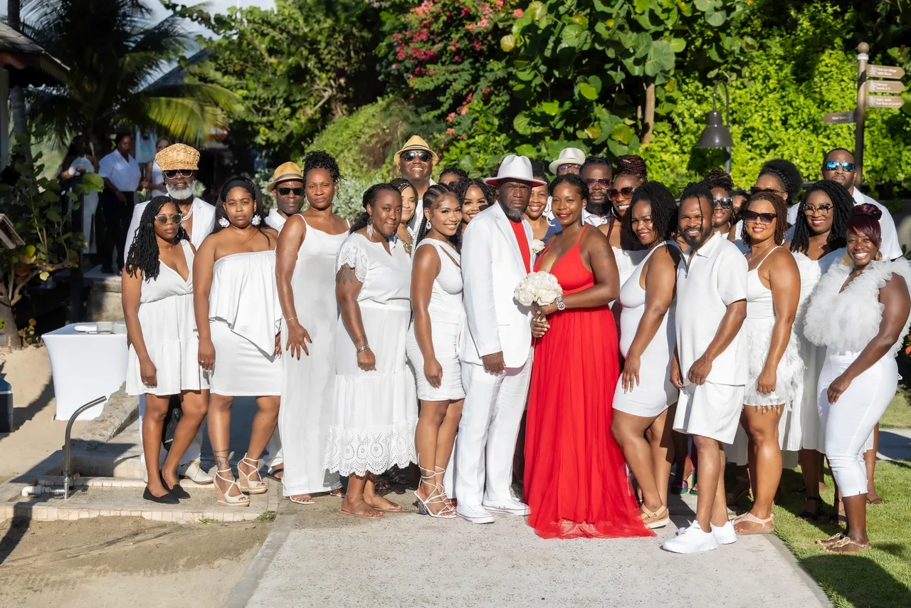 A group of people in white outfits posing for the camera.