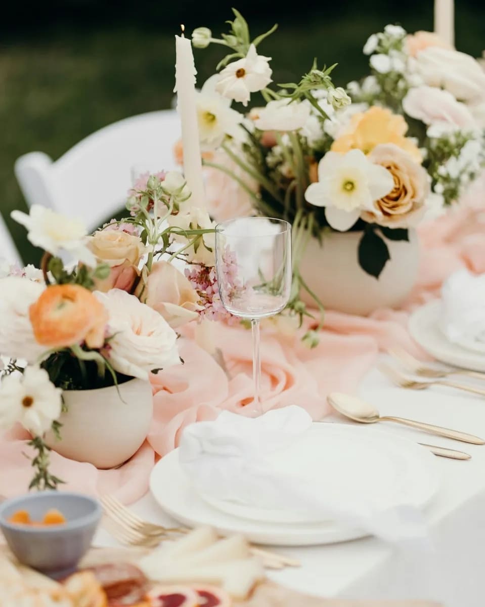 A table with flowers and candles on it