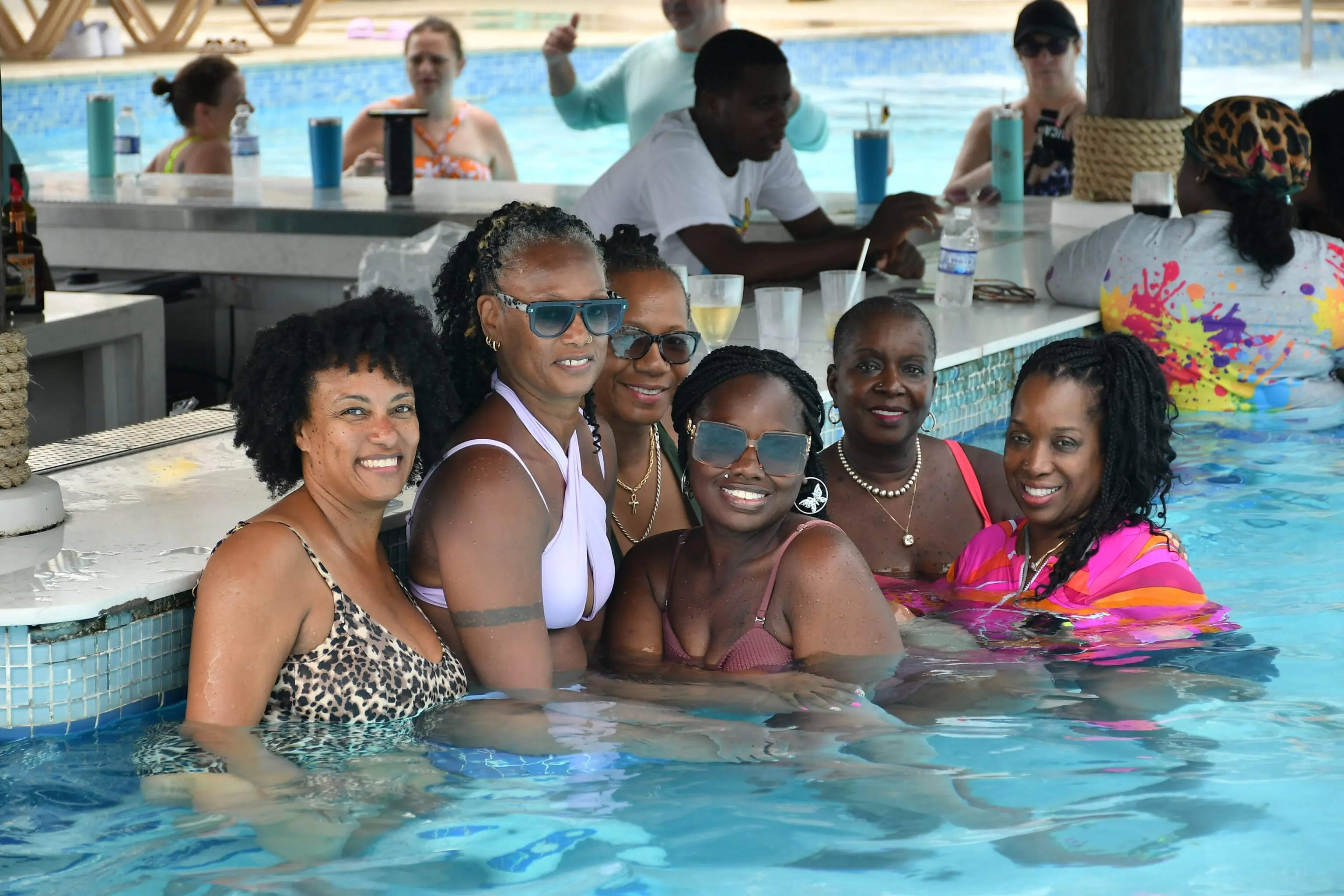 A group of women in the pool at a resort.
