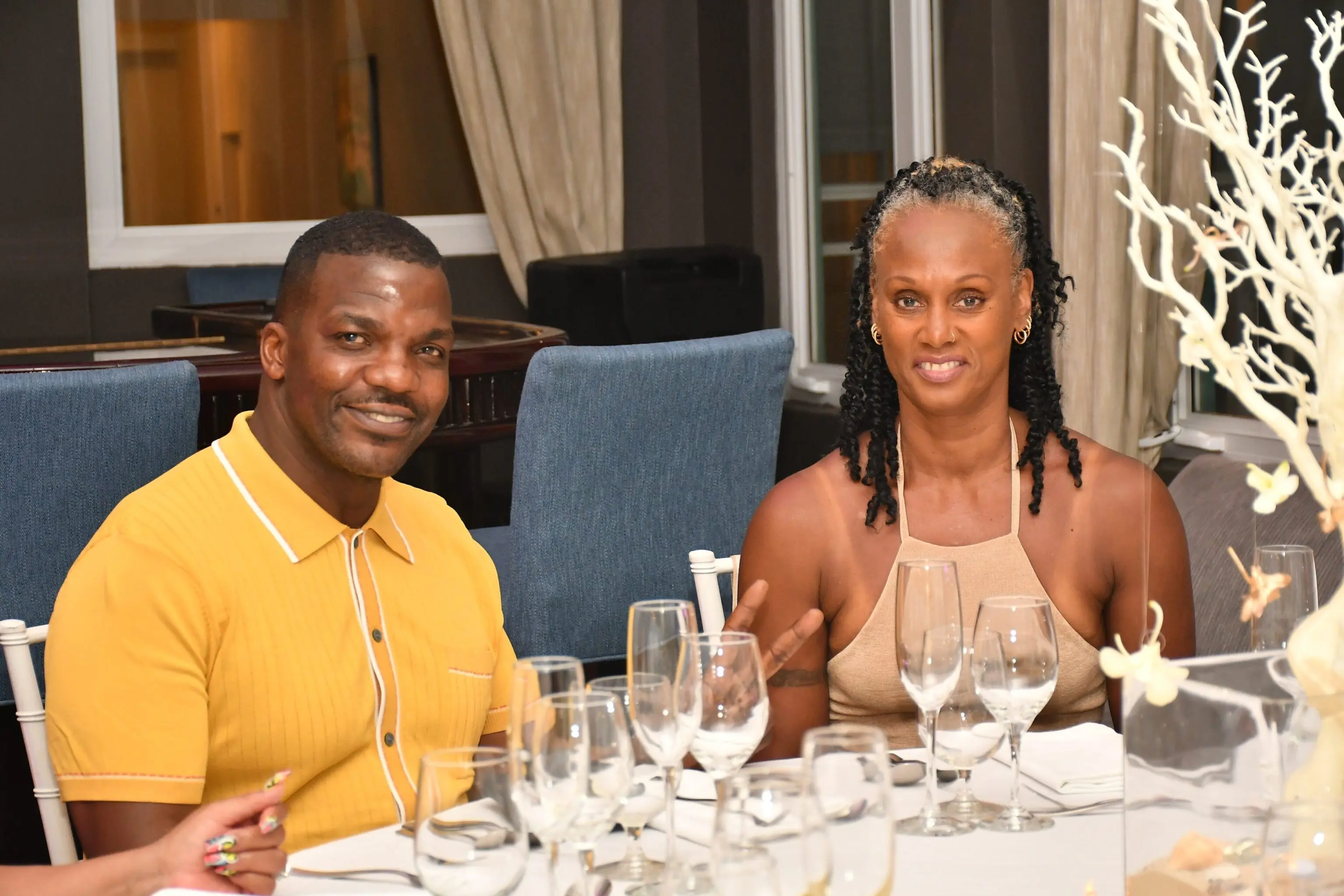 Man and woman seated at a dinner table.