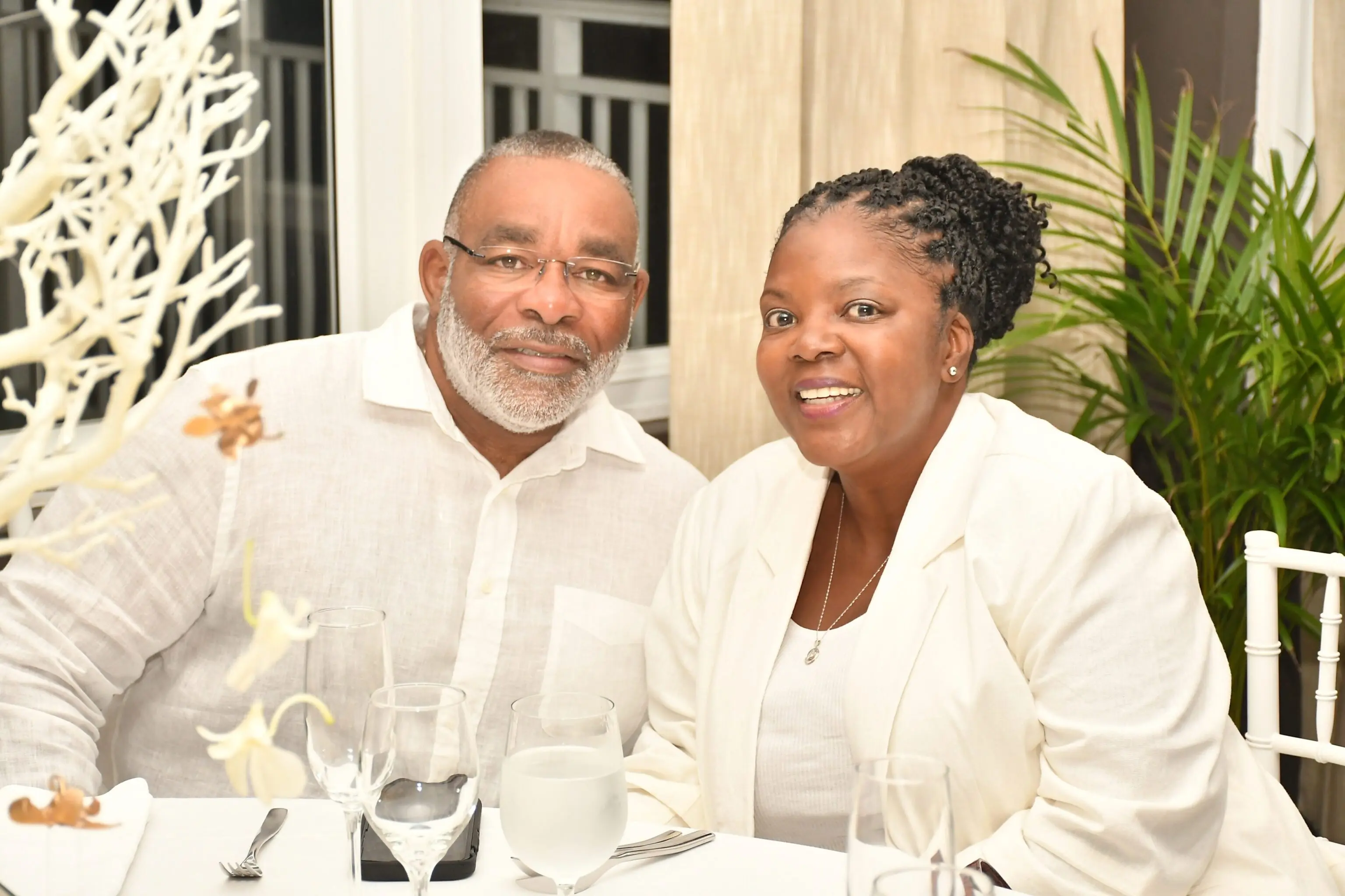 Smiling couple sitting at a table.