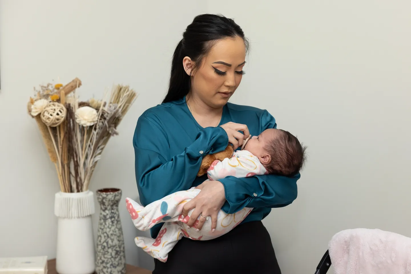 Woman holding a baby in her arms.