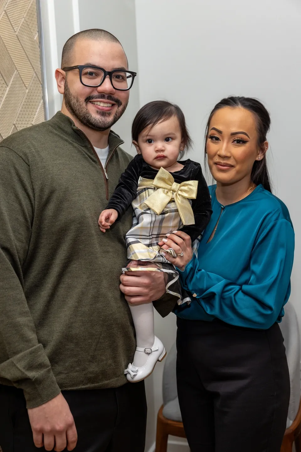 Family portrait with baby girl in dress.