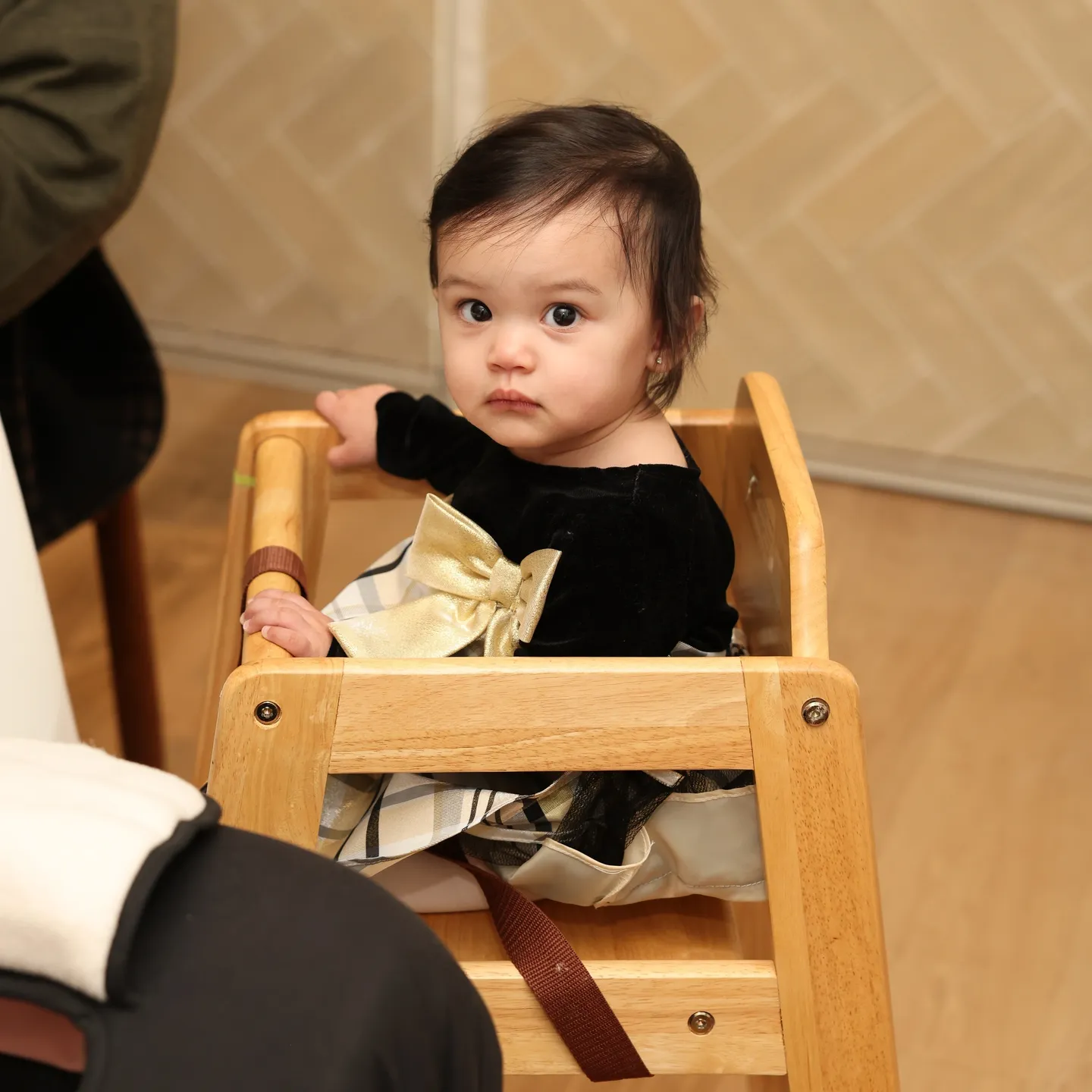 Baby girl sitting in a high chair.