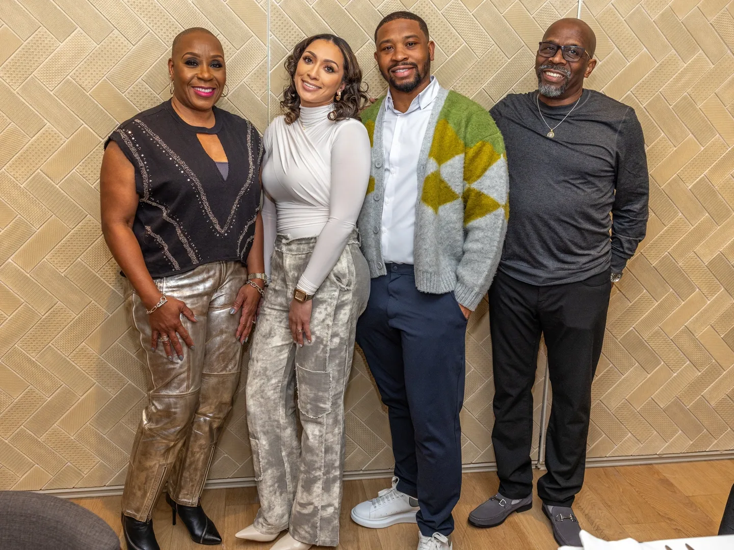 Four people smiling for a photo.