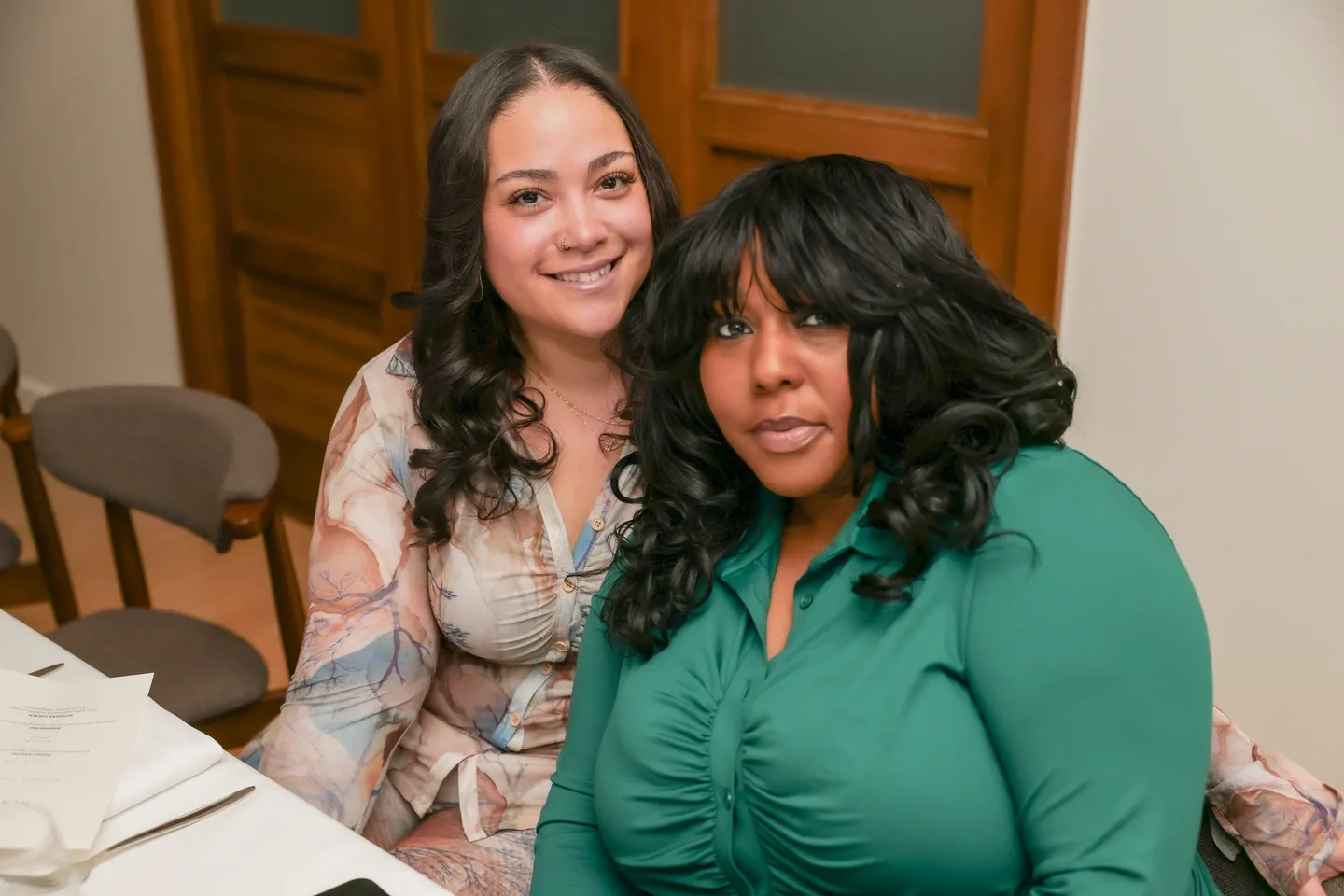 Two women smiling at the camera.