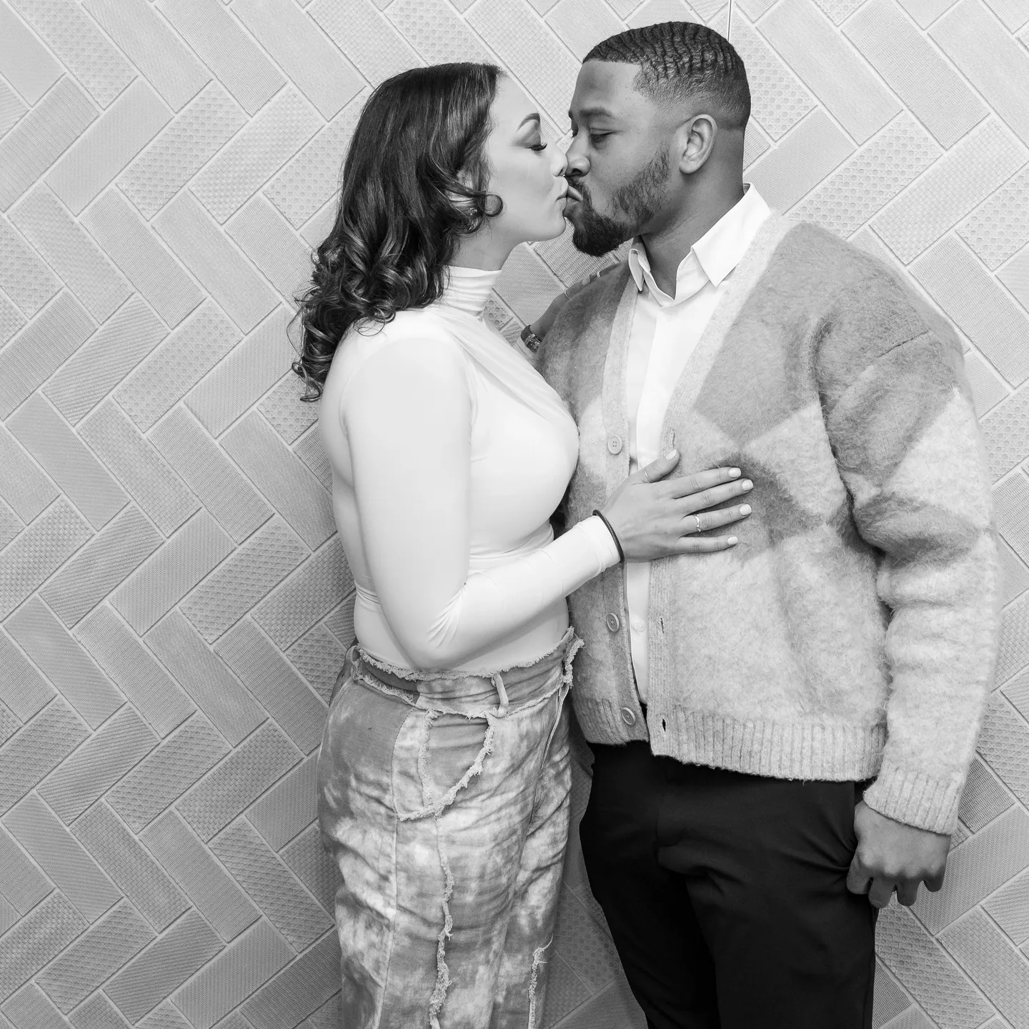 Black and white photo of a couple kissing.