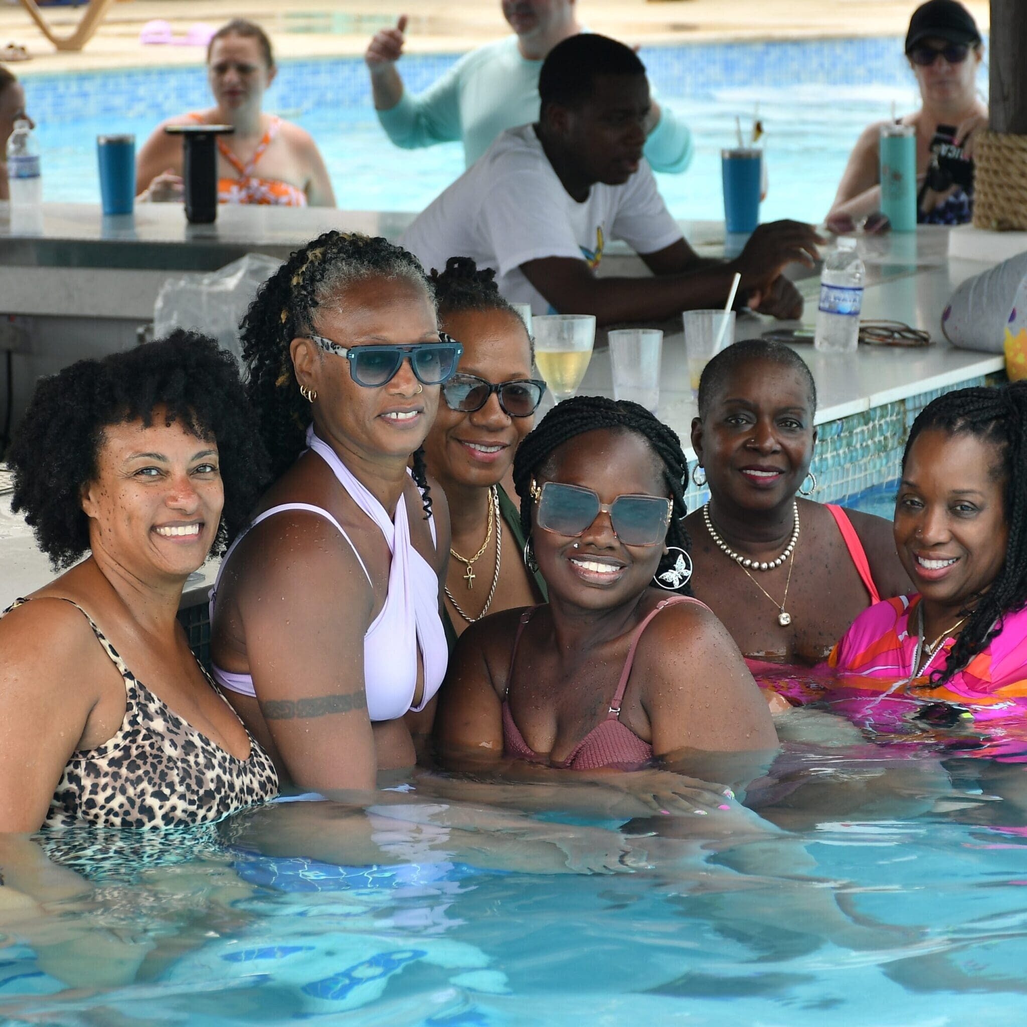 A group of women in the pool at a resort.